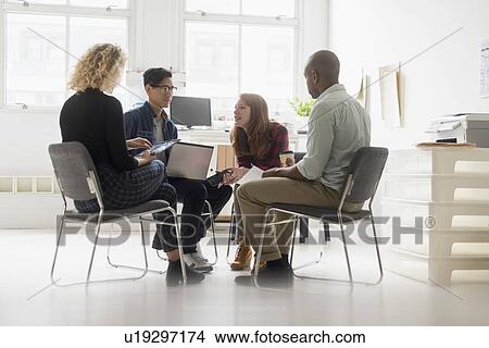 Friends having business meeting in office View Large Photo Image Picture - Friends having business meeting in office. Fotosearch