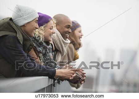 Friends standing on bridge and laughing View Large Photo Image Stock Image - Friends standing on bridge and laughing. Fotosearch