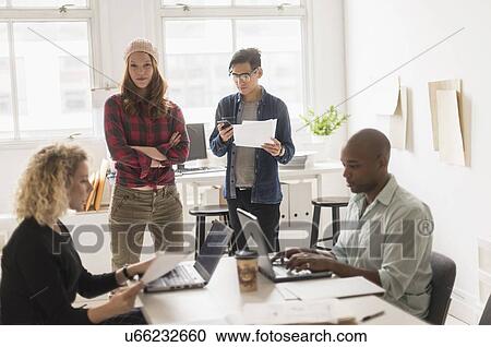 Friends working in office View Large Photo Image Stock Image - Friends working in office. Fotosearch