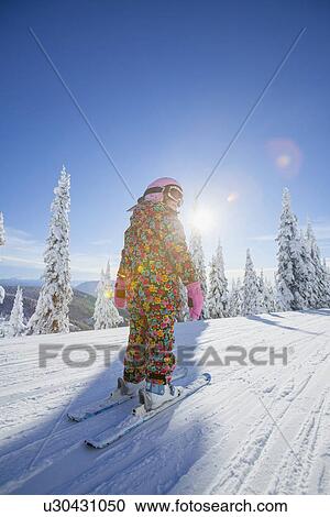 Girl (8-9) skiing in mountains View Large Photo Image Stock Image - Girl (8-9) skiing in mountains. Fotosearch