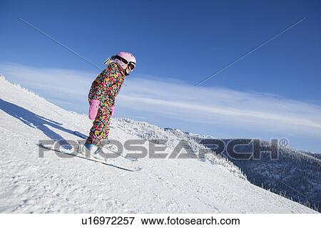 Girl (8-9) skiing in mountains View Large Photo Image Stock Photo - Girl (8-9) skiing in mountains. Fotosearch