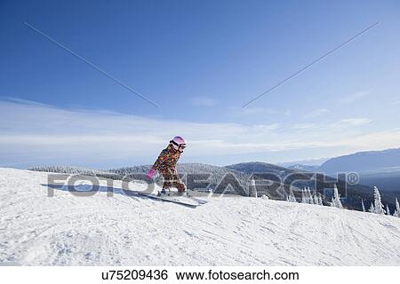 Girl (8-9) skiing in mountains View Large Photo Image Stock Photograph - Girl (8-9) skiing in mountains. Fotosearch