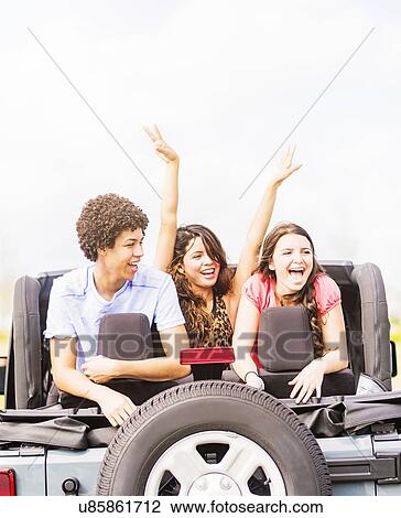 Stock Image - Group of friend (14-15) during road trip. Fotosearch