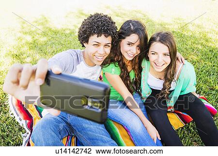 Group of friends (14-15) making selfie View Large Photo Image Stock Image - Group of friends (14-15) making selfie. Fotosearch