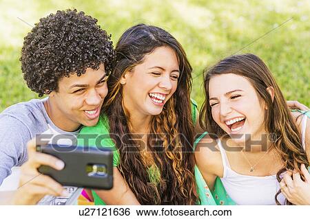 Group of friends (14-15) making selfie View Large Photo Image Stock Photograph - Group of friends (14-15) making selfie. Fotosearch