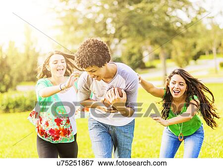 Group of friends (14-15) playing football in park View Large Photo Image Stock Photo - Group of friends (14-15) playing football in park. Fotosearch