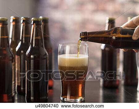 Hand pouring beer View Large Photo Image Stock Image - Hand pouring beer. Fotosearch