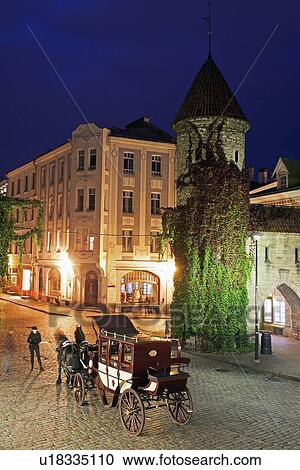 Stock Image - Horse cart on street at night. Fotosearch