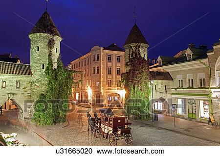Stock Image - Horse cart on street at night. Fotosearch