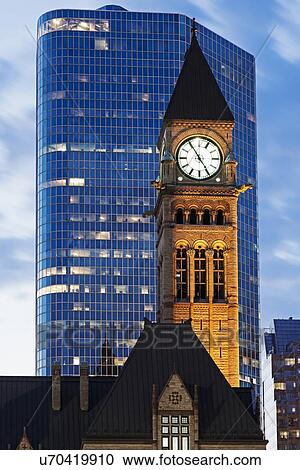 Illuminated clock tower and skyscraper at sunrise View Large Photo Image Stock Image - Illuminated clock tower and skyscraper at sunrise. Fotosearch
