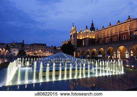Illuminated fountain and Cloth Hall at dusk View Large Photo Image Stock Photography - Illuminated fountain and Cloth Hall at dusk. Fotosearch