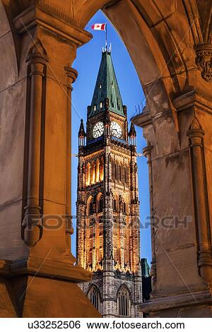 Illuminated Peace Tower seen through lancet arch View Large Photo Image Stock Photograph - Illuminated Peace Tower seen through lancet arch. Fotosearch