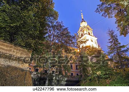 Illuminated spire of Rzeszow Castle seen through trees View Large Photo Image Stock Photograph - Illuminated spire of Rzeszow Castle seen through trees. Fotosearch