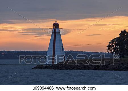 Stock Photograph - Lighthouse at sunset. Fotosearch