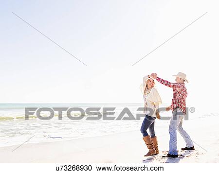 Loving couple dancing on beach View Large Photo Image Stock Image - Loving couple dancing on beach. Fotosearch