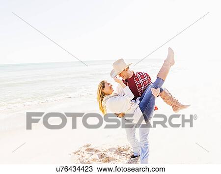 Stock Image - Loving couple dancing on beach. Fotosearch