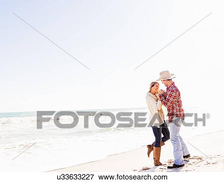 Loving couple dancing on beach View Large Photo Image Stock Photo - Loving couple dancing on beach. Fotosearch