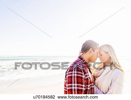 Stock Image - Loving couple on beach. Fotosearch
