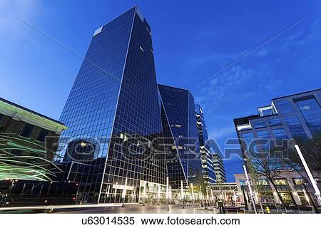 Low angle view of city street with glass skyscrapers View Large Photo Image Stock Photography - Low angle view of city street with glass skyscrapers. Fotosearch