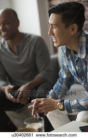 Man laughing during meeting with friends View Large Photo Image Stock Image - Man laughing during meeting with friends. Fotosearch