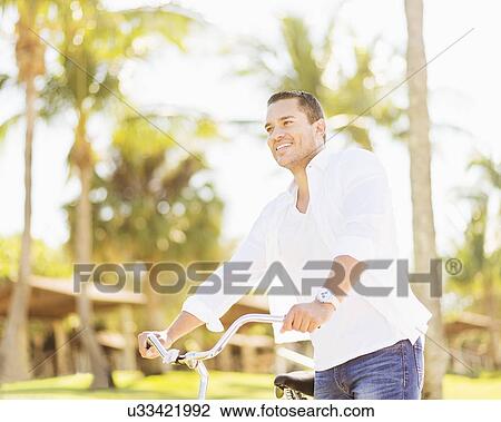 Stock Image - Man riding bike. Fotosearch
