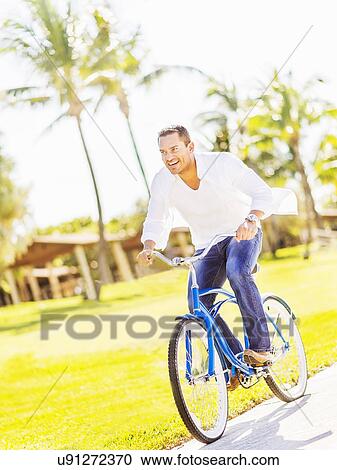 Man riding bike View Large Photo Image Stock Image - Man riding bike. Fotosearch