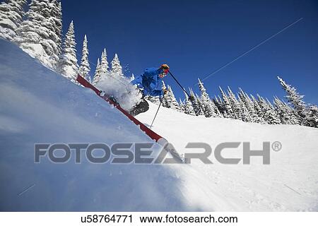 Man skiing in mountains View Large Photo Image Stock Image - Man skiing in mountains. Fotosearch