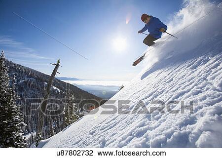 Man skiing in mountains View Large Photo Image Stock Image - Man skiing in mountains. Fotosearch