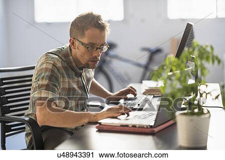 Man using computer in office View Large Photo Image Stock Image - Man using computer in office. Fotosearch