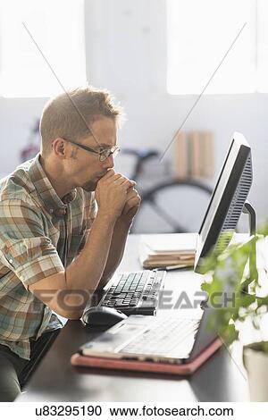 Man using computer in office View Large Photo Image Stock Image - Man using computer in office. Fotosearch