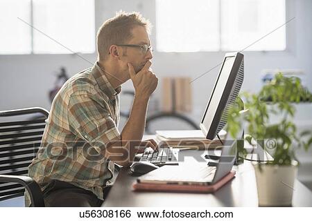 Man using computer in office View Large Photo Image Stock Photograph - Man using computer in office. Fotosearch