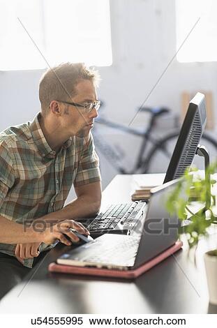 Man using computer in office View Large Photo Image Stock Photography - Man using computer in office. Fotosearch