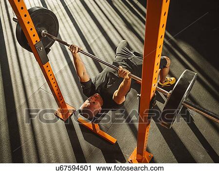 Mature man bench pressing View Large Photo Image Stock Image - Mature man bench pressing. Fotosearch