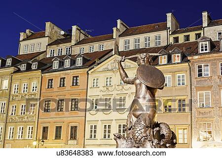 Stock Image - Mermaid of Warsaw against buildings. Fotosearch