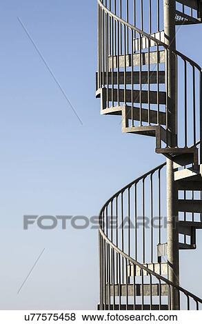 Stock Photo - Metal stairway against blue sky. Fotosearch