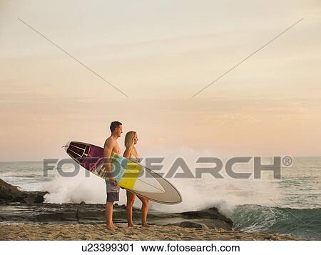 Mid-adult couple looking at sea View Large Photo Image Stock Image - Mid-adult couple looking at sea. Fotosearch