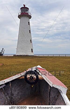 Old rowboat against lighthouse View Large Photo Image Stock Photo - Old rowboat against lighthouse. Fotosearch