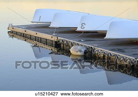 Overturned boats resting on dock View Large Photo Image Stock Photo - Overturned boats resting on dock. Fotosearch