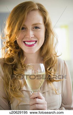 Stock Photography - Portrait of attractive woman holding wine glass. Fotosearch