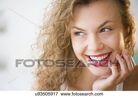 Stock Photo - Portrait of attractive young woman laughing. Fotosearch