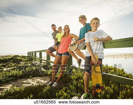 Portrait of family with three children (6-7, 10-11, 14-15) on vacation View Large Photo Image Stock Photography - Portrait of family with three children (6-7, 10-11, 14-15) on vacation. Fotosearch