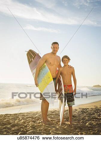 Portrait of father and his son (14-15) on beach View Large Photo Image Stock Photograph - Portrait of father and his son (14-15) on beach. Fotosearch