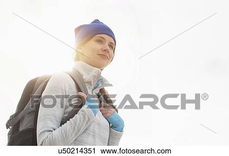 Stock Image - Portrait of female tourist with backpack. Fotosearch