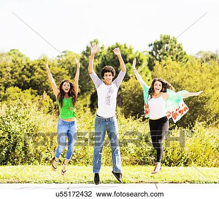 Portrait of friends (14-15) jumping View Large Photo Image Stock Image - Portrait of friends (14-15) jumping. Fotosearch