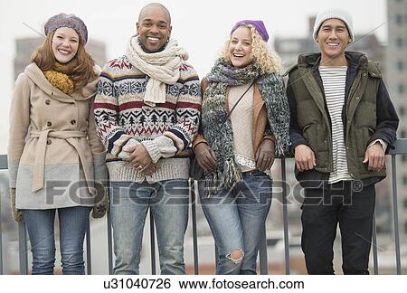 Portrait of happy friends leaning against bridge railing View Large Photo Image Stock Photograph - Portrait of happy friends leaning against bridge railing . Fotosearch