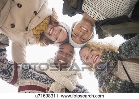 Portrait of happy friends, low angle view View Large Photo Image Stock Image - Portrait of happy friends, low angle view. Fotosearch