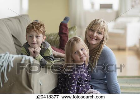 Stock Photo - Portrait of happy mother with children (4-5, 6-7) . Fotosearch