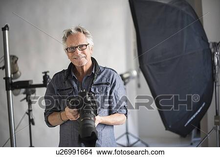 Portrait of photographer in his studio View Large Photo Image Picture - Portrait of photographer in his studio. Fotosearch