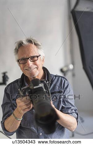 Portrait of photographer in his studio View Large Photo Image Stock Image - Portrait of photographer in his studio. Fotosearch
