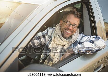 Stock Image - Portrait of smiling car owner. Fotosearch